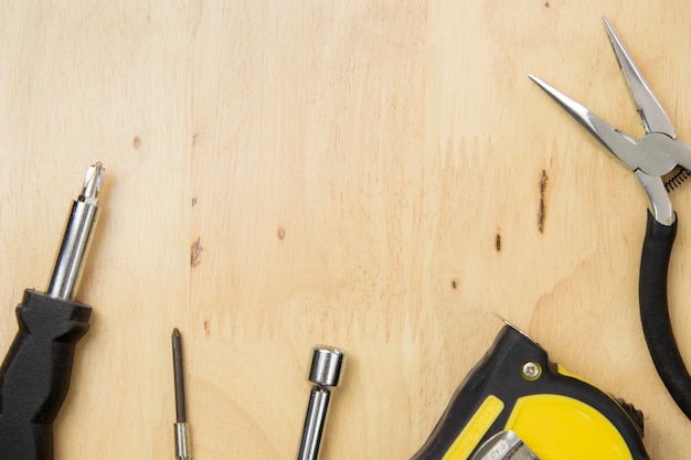 Desk of a craftsman tools on a wooden background. top view, flat lay concept.