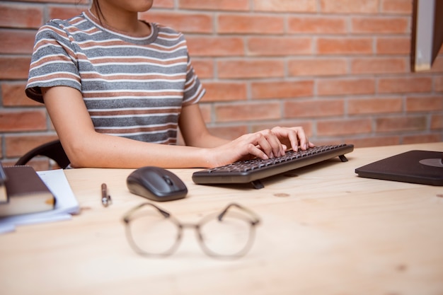 Desk and hands close up in home office 