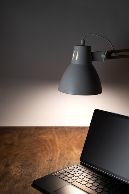 Desk lamp illuminates the workplace on the office desk and
outdoor laptop