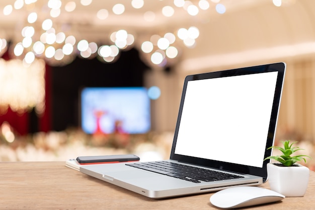 Desk Laptop with blank screen on table  blur background with bokeh background that is used for editing.