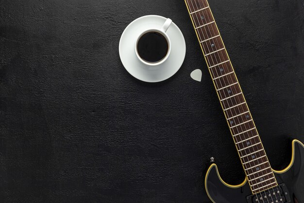 Desk of musician for songwriter work set with headphones and guitar