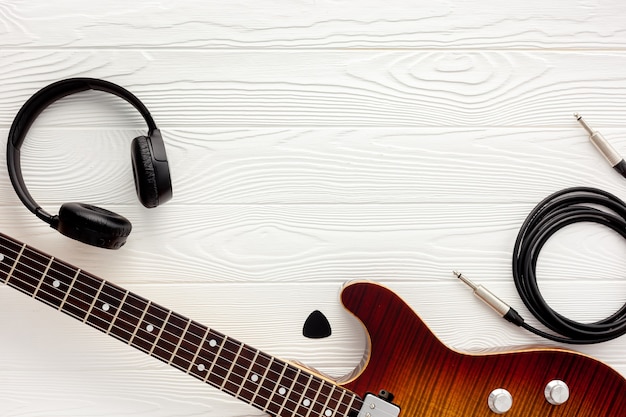 Desk of musician for songwriter work set with headphones and guitar