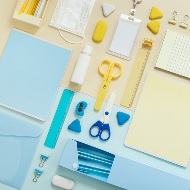 Desk school with office supplies and personal protective equipment