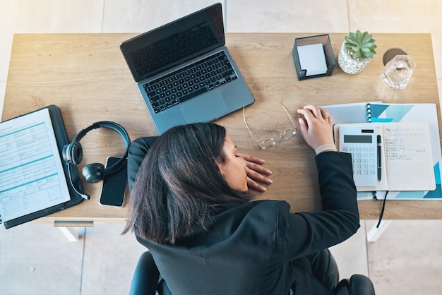 Photo desk sleeping and woman above in a finance office with rest and nap from work burnout accountant deadline and tired female professional with administration project for tax paperwork at a company