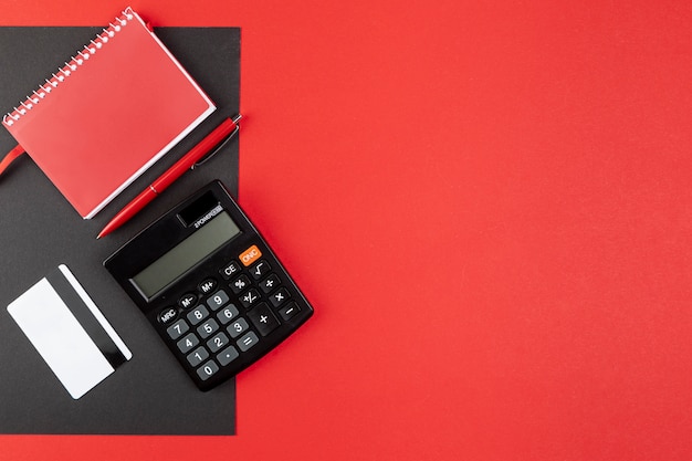 Photo desk stuff on red background with copy space