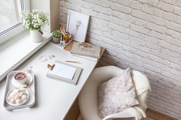 Desk with a cup of tea and marshmallows