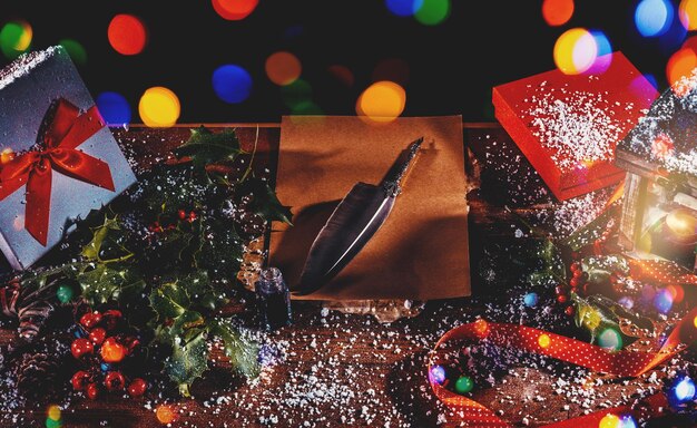 Desk with presents and a blank letter to santa claus