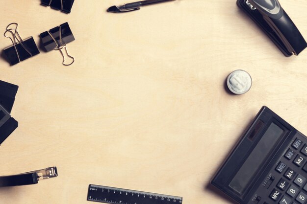 Photo desk with various office tools and calculator