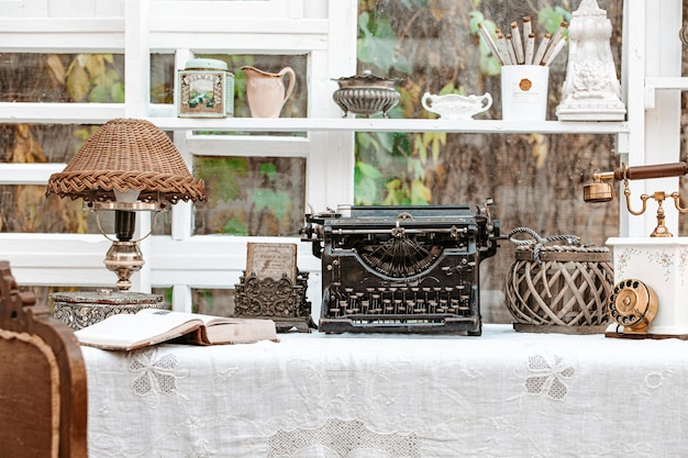 Photo desk with vintage typewriter retro lamp old phone