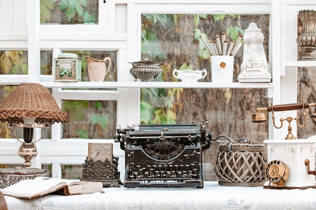 Desk with vintage typewriter retro lamp old phone