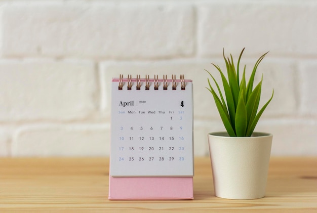 Desktop calendar for April 2022 for planning on the table