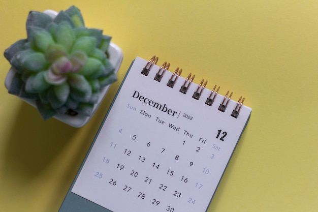 Desktop calendar for December 2022 on a yellow background