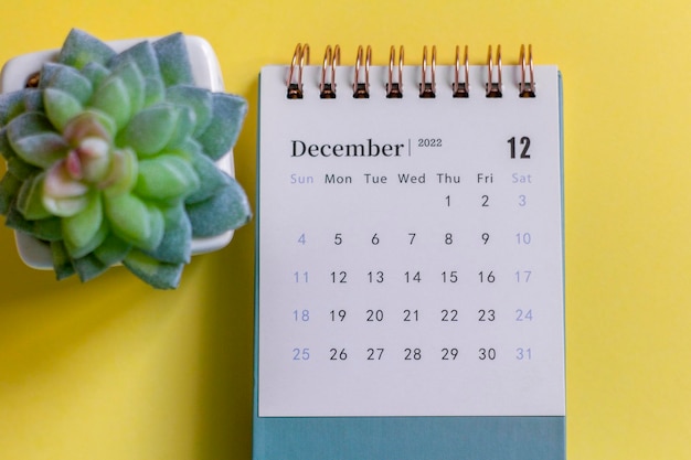 Desktop calendar for December 2022 on a yellow background