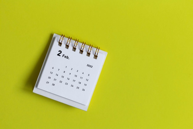 Desktop calendar for february 2022 on a yellow background