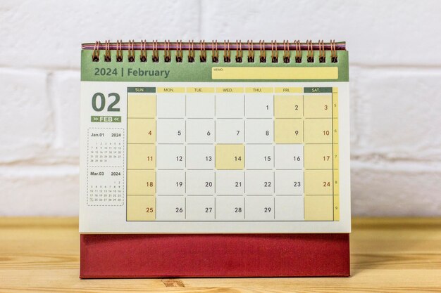 Desktop calendar for February 2024 on the table