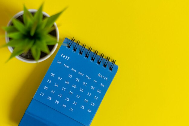 Desktop calendar for March 2022 on a yellow background