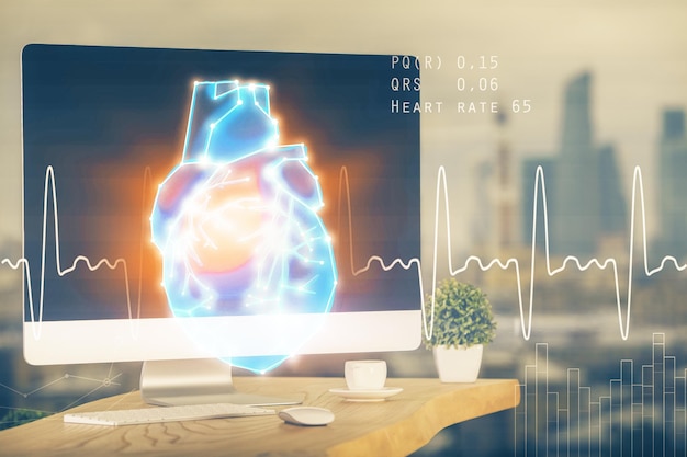 Desktop computer background and heart drawing Double exposure Medical study and healthcare concept