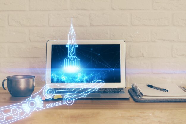 Desktop computer background in office and start up theme hologram drawing Double exposure Startup concept