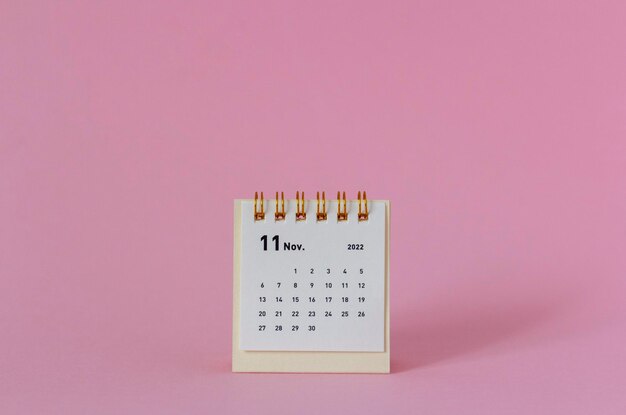 Desktop mini calendar for November 2022 on a pink background