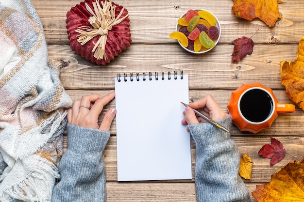 Desktop mock up planner with hands and autumn leaves