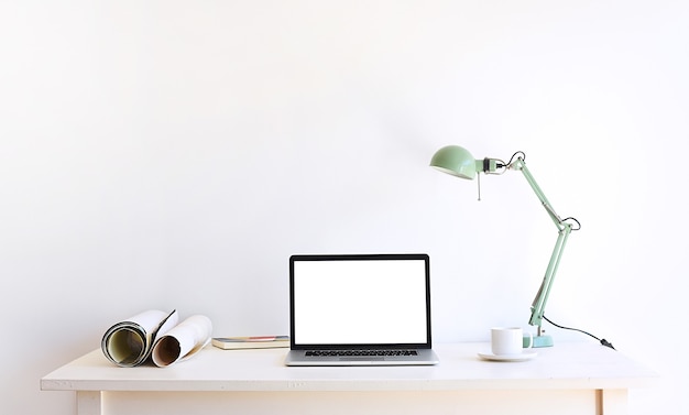 Desktop setup for designer or content creator at work table.\
flat laptop screen and objects on white background