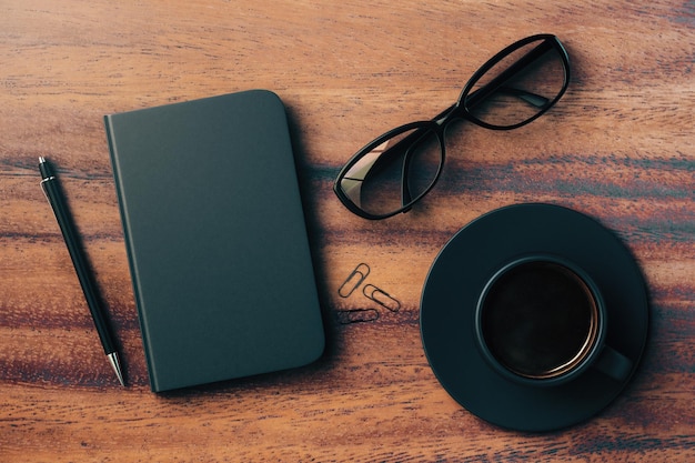 Desktop with notepad cup and glasses