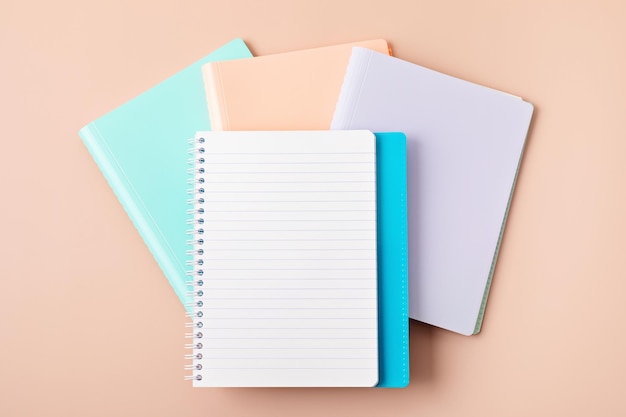 Desktop with school stationary and office supplies over pastel background