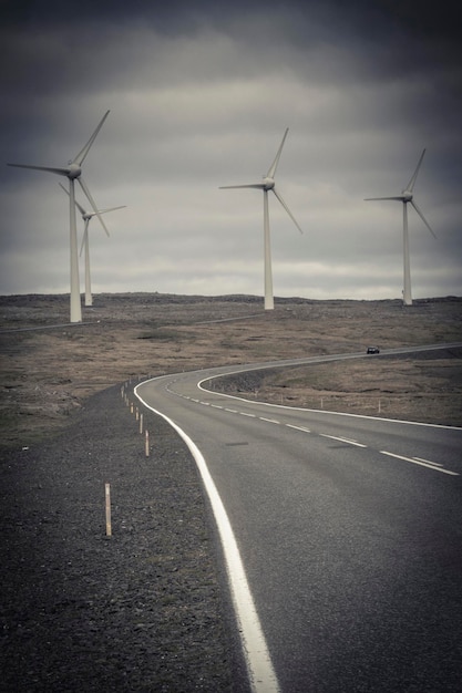 Desolate road and wind turbines