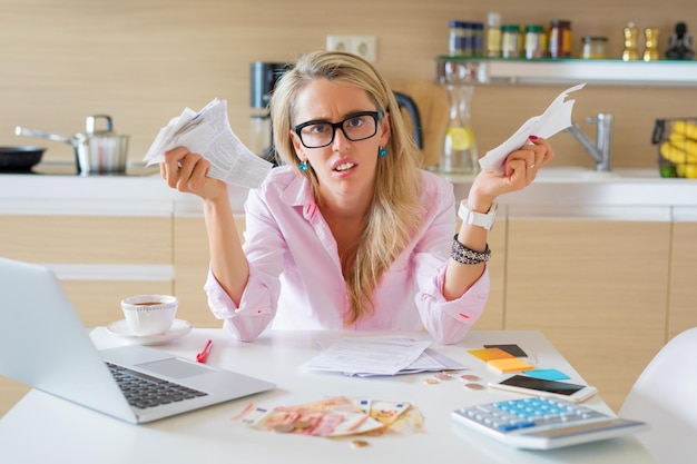 Photo desperate woman with too many bills to pay