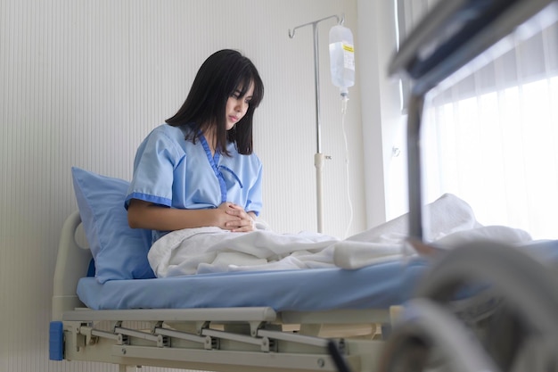 A despondent Asian woman patient Following the doctor's declaration that the cancer course