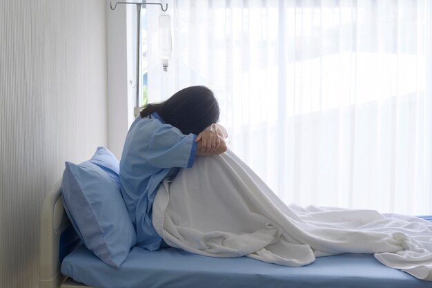 A despondent Asian woman patient Following the doctor's declaration that the cancer