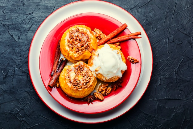 Dessert, baked apples with granola and nuts.Tasty baked apples with ice cream.Healthy autumn fruit dessert