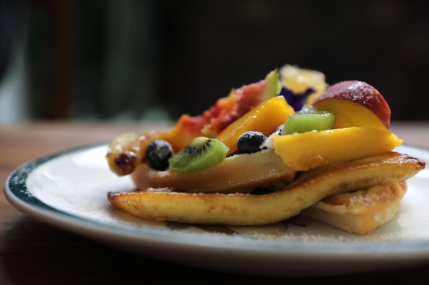 Dessert baked Waffle with fruits kiwo grape berry and vanilla ice cream vintage style