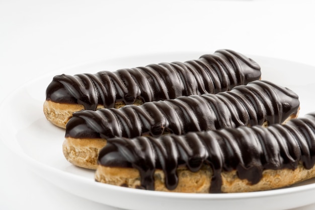 Dessert Bomba de Chocolate. Brazilian traditional ÃÂ©clair on a white background.  Selective focus.