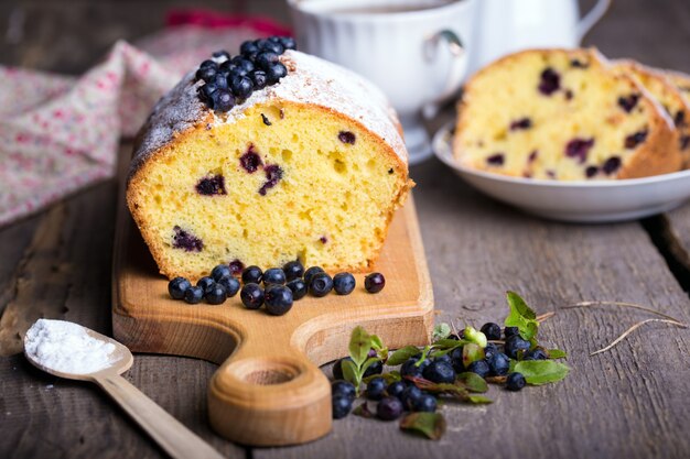 Dessert bosbessencake en thee op een houten tafel