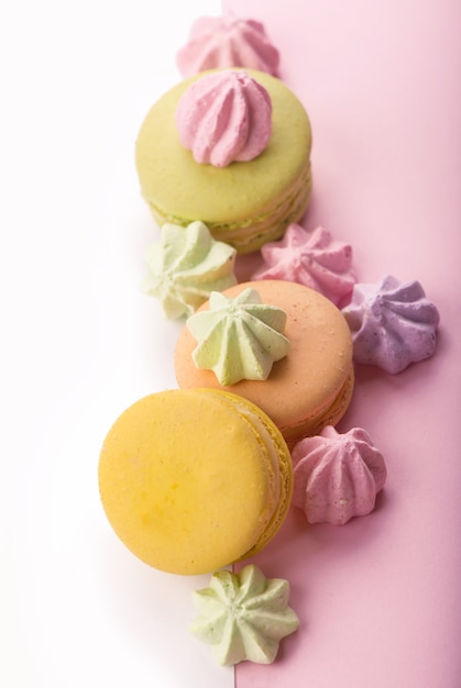 Dessert cake macaron or macaroon on pink background top view.