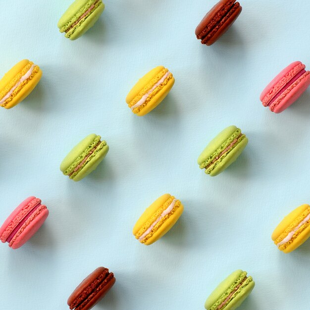 Dessert cake macaron or macaroon on trendy pastel blue background top view. Flat lay composition