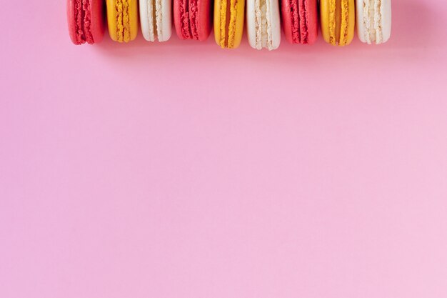 dessert cake macaron on pink background top view. 