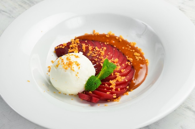 Dessert Caramelized pear with ice cream on a plate Top view