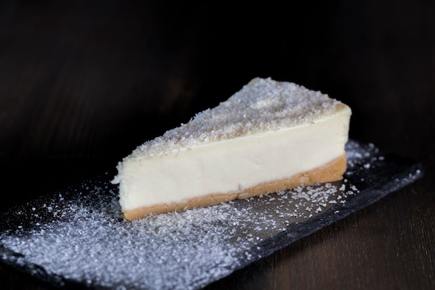 Dessert cheesecake covered with dried coconut pulp