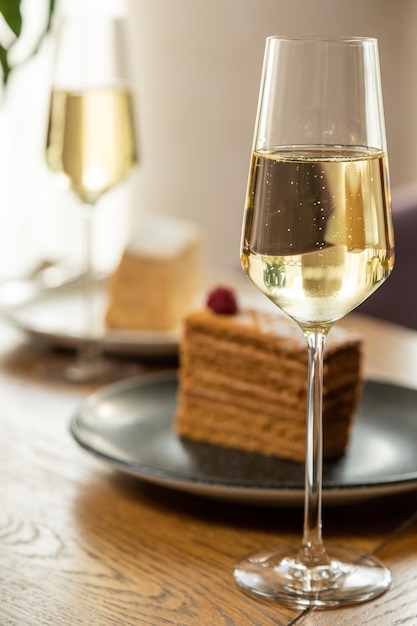 Dessert decorated with raspberries, served with champagne. Photo of dessert in the interior