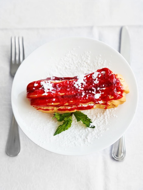 Dessert eclair on white plate