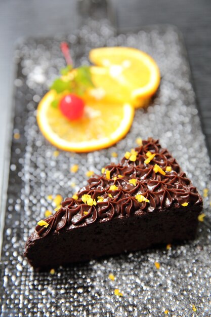 Dessert food orange chocolate cake on wood background