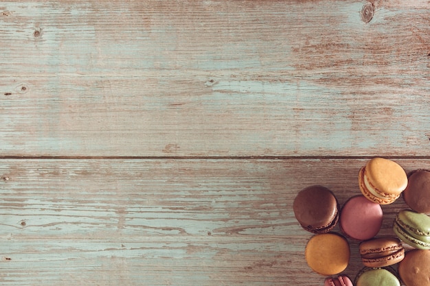 Dessert of French macarons in pastel colors on wood Copy space Selective focus