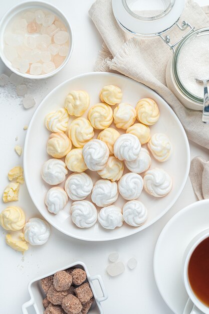 Dessert French meringues on a light background. The concept of confectionery products. Top view.