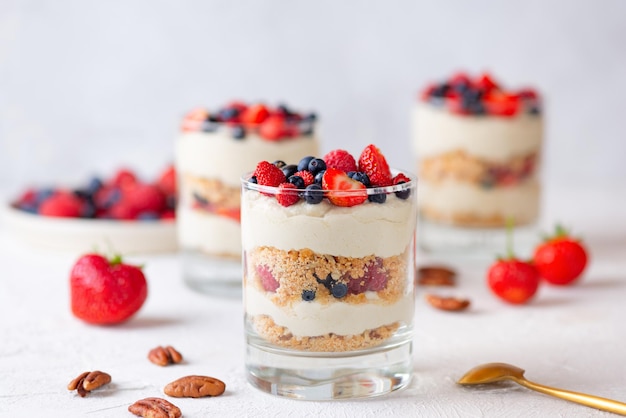 Dessert in een glas met bessen, slagroom en koekjes, veganistisch, suikervrij, glutenvrij en lactosevrij.