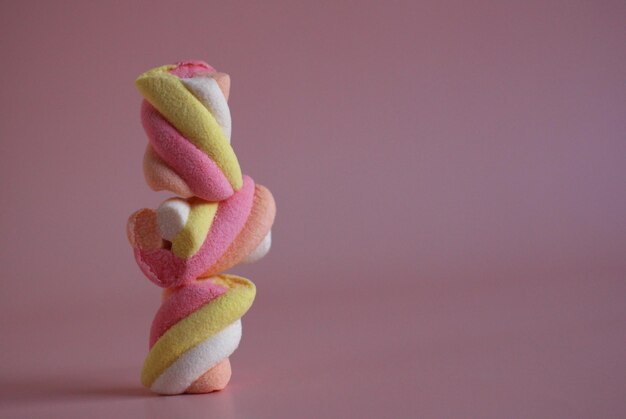 Dessert multicolored air marshmallows on a pink background