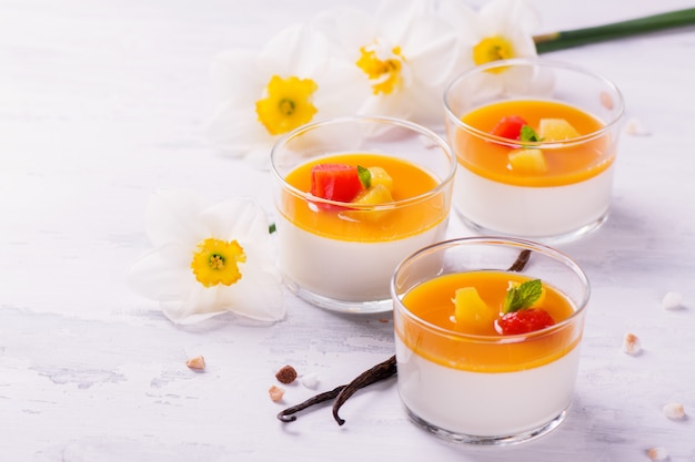 Dessert panna cotta with fresh berries on wooden background