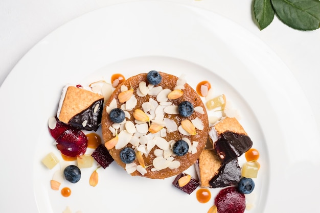 Dessert pastries and confectionery assortment on white background. delicious restaurant food. overeating problems.