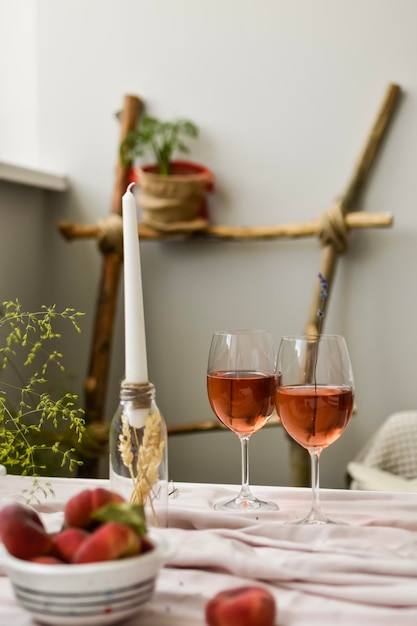 Dessert peaches and glass of wine on minimal white background